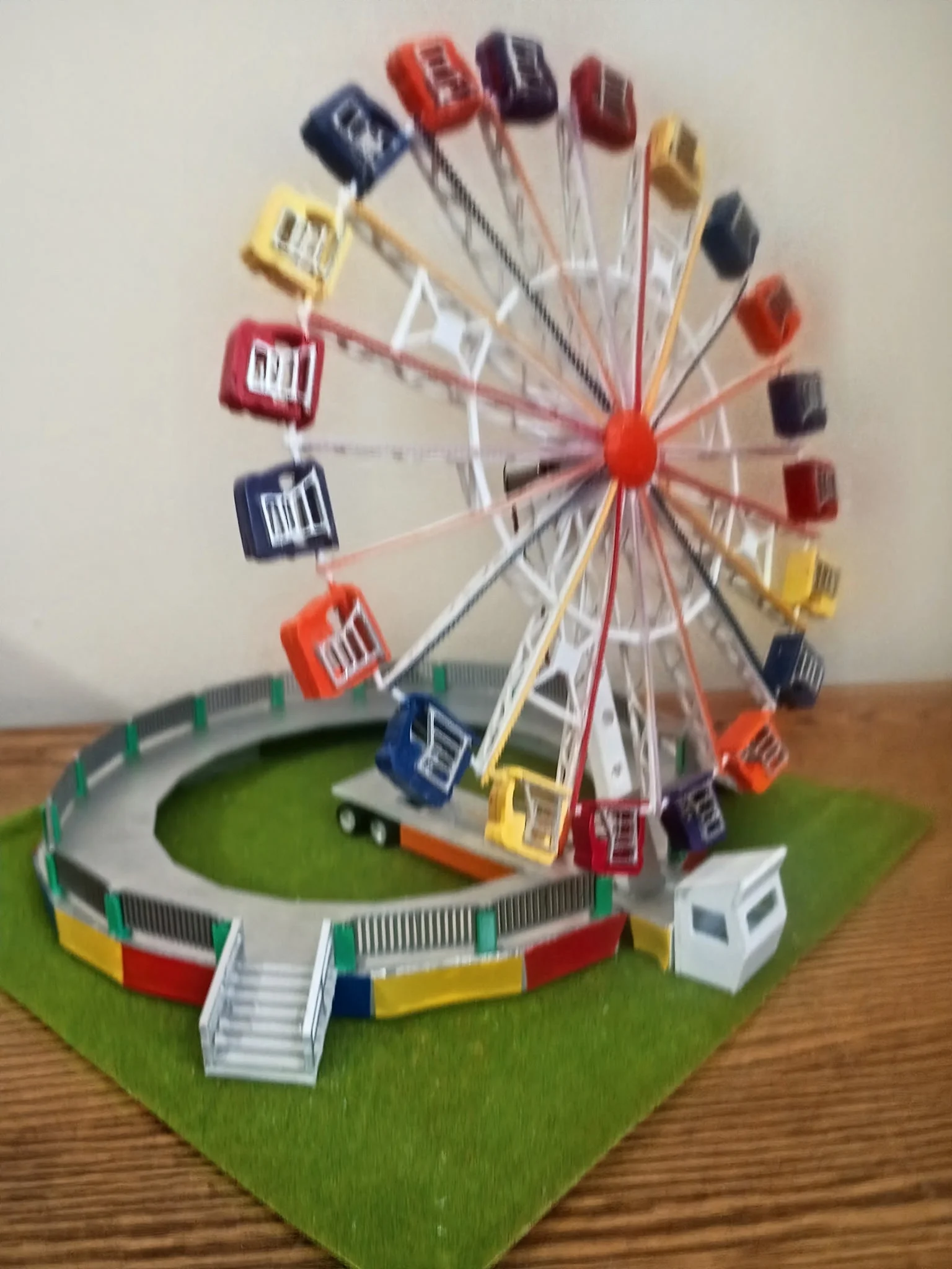 Handcrafted HO scale Huss Enterprise with colorful gondolas on a green base